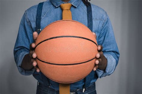 Cropped Image Of African American Man Holding Basketball Ball Stock