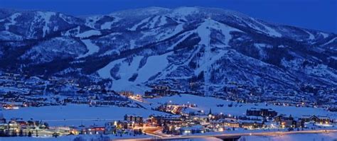 The Mountains Are Covered In Snow And Lit Up At Night With Lights