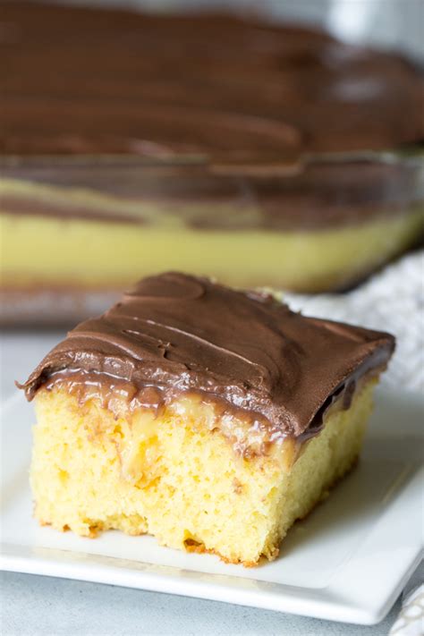 Super moist cake, topped with a fudgy chocolate frosting. Boston Cream Poke Cake