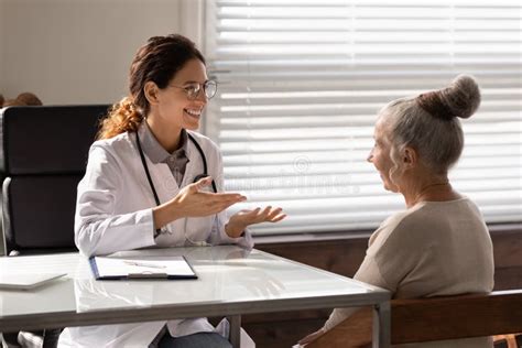 Smiling Female Gp Consult Mature Woman Client Stock Photo Image Of