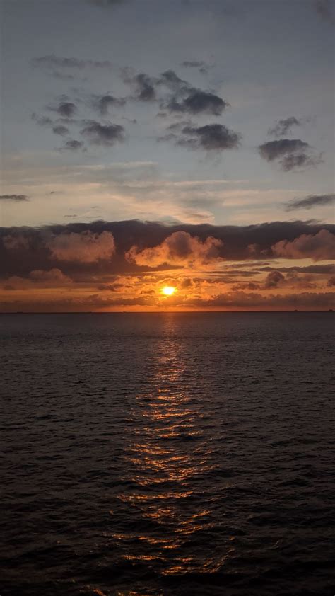 Download Wallpaper 938x1668 Sea Horizon Clouds Sun Sunset Dark