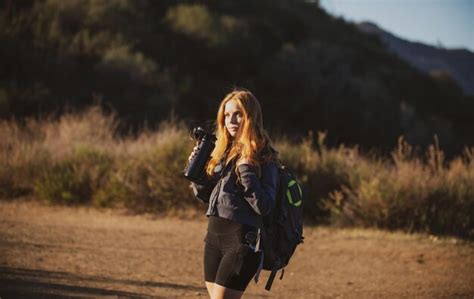 premium photo tourism concept woman hiker with backpack at hills tourist girl hiking in