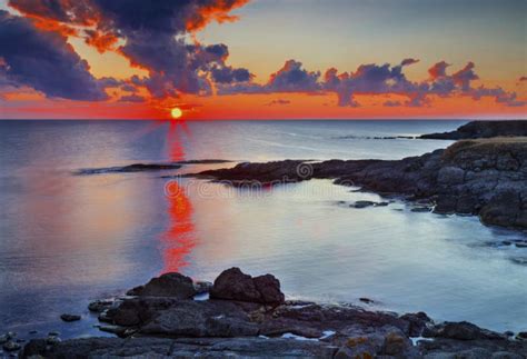Sunrise On Rocky Shore And Dramatic Sky Clouds Stock Image Image Of