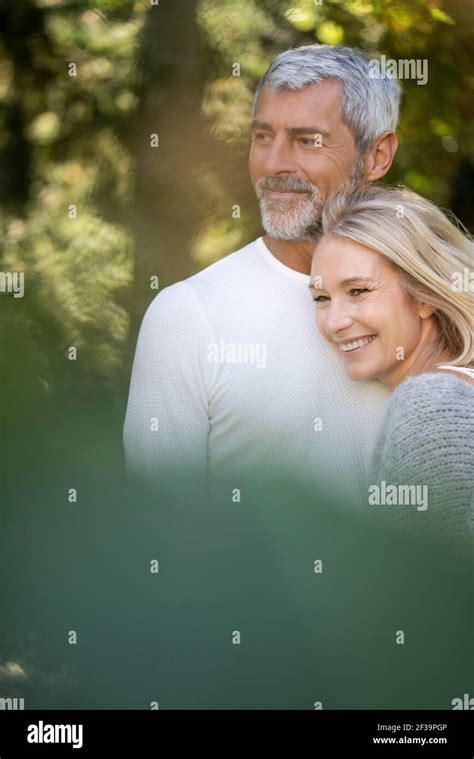 Smiling Mature Couple Embracing Each Other In Backyard Stock Photo Alamy