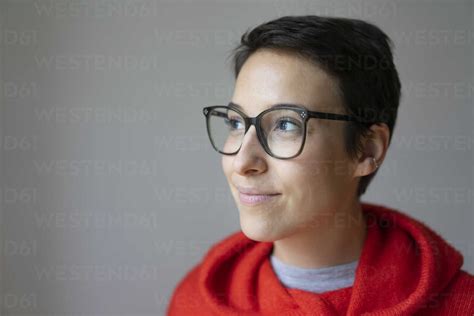 Portrait Of A Smiling Young Woman With Short Hair Wearing Glasses