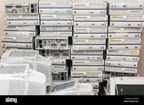 Junked Computers Stored In Room Piles Of Stacked White Computer Bases