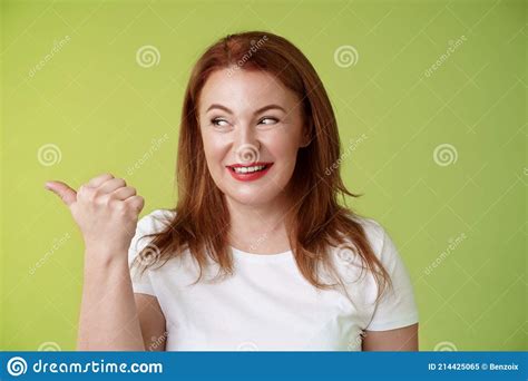 Intrigued Charismatic Redhead Middle Aged Woman Smiling Temtation Interest Pointing Looking Left