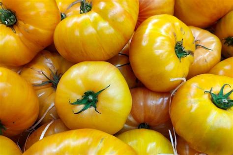 Premium Photo Stack Of Yellow Heirloom Tomatoes