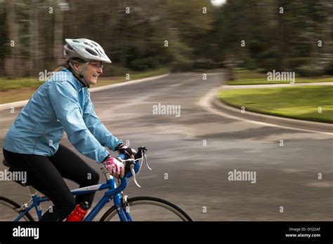 Mature Woman Rides Her Bicycle With Approved Safety Gear Usa Stock