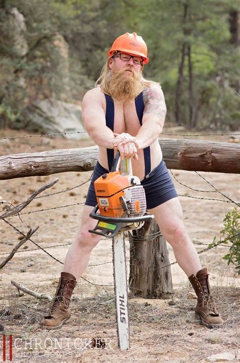 a man with a beard sitting on top of a tree stump holding a chainsaw