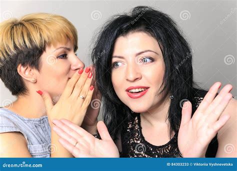 Portrait Of A Gossip Girl Telling A Secret In The Ear To Her Friend