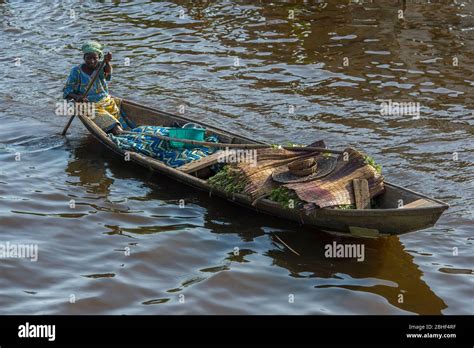 Ganvie Village Scene With Woman Paddling Boat Is A Unique Village