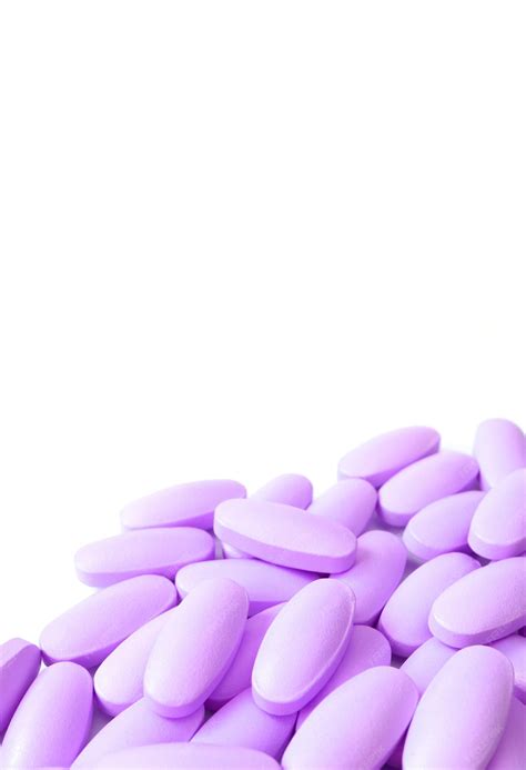 Premium Photo | Pile of purple pills on white backdrop with copy space