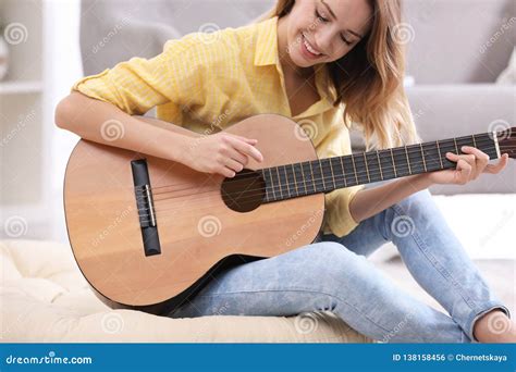 Young Woman Playing Acoustic Guitar Stock Photo - Image of indoors