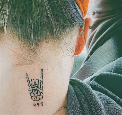 A Woman With A Tattoo On Her Neck Has A Peace Sign Behind Her Back Shoulder