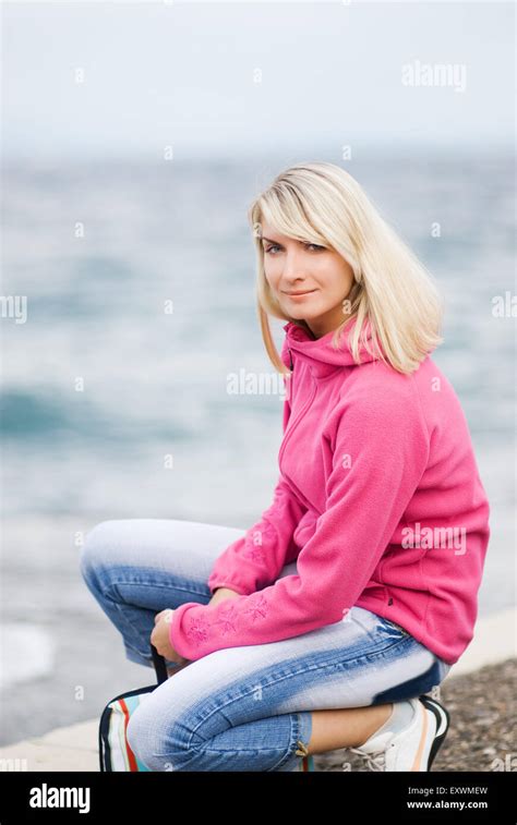 Beautiful Young Woman Relaxing Near The Ocean Stock Photo Alamy