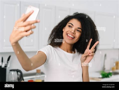Happy Beautiful African American Woman Taking Selfie On Mobile Phone Camera Showing Victory