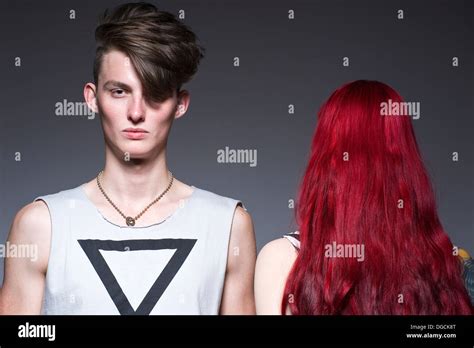 Young Man Standing Next To Woman With Red Hair Portrait Stock Photo