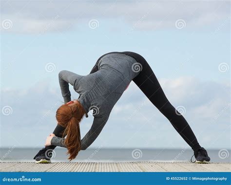 Sporty Woman Bending Down And Stretching Exercise Stock Photo Image