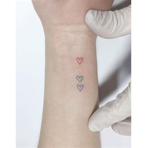 Colorful Hearts Tattoo Done On The Wrist