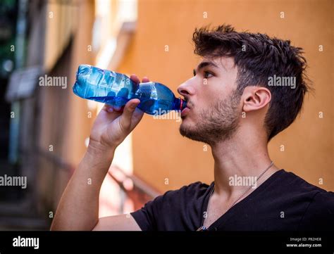 Handsome Young Man Drinking Water From Bottle Stock Photo Alamy