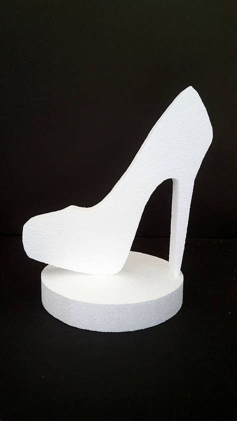 A White Shoe Shaped Sculpture Sitting On Top Of A Table