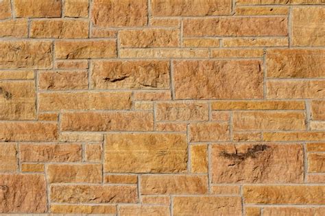 Tan Color Vintage Limestone Block Wall With Rough Texture In Full