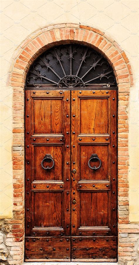 An Old Wooden Door With Wrought Iron Bars