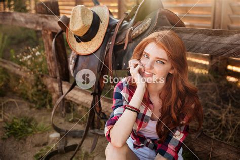 Close Up Portrait Of A Happy Beautiful Redhead Cowgirl Resting At The