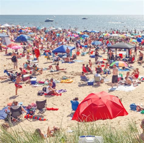 Beach Scene On A Busy Summer Day With Blurred Out People Focus On