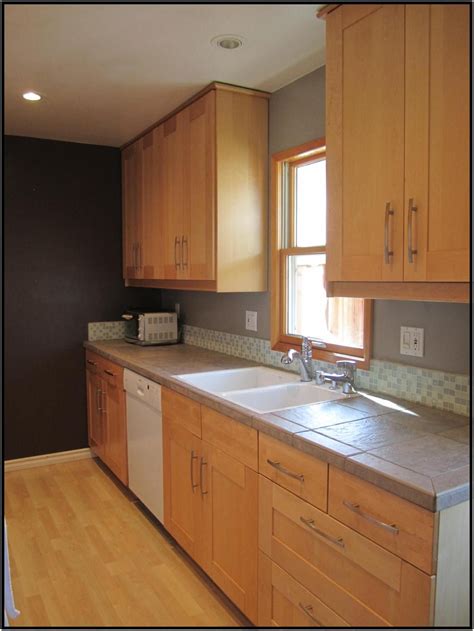 Looking for something other than a tile backsplash? Maple cabinets, gray counters and short glass backsplash ...