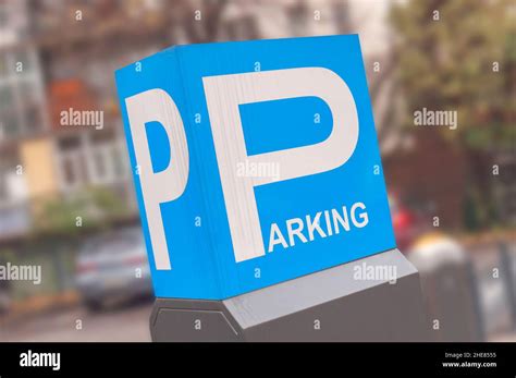 Blue Parking Sign With Parked Blurry Car Background Stock Photo Alamy