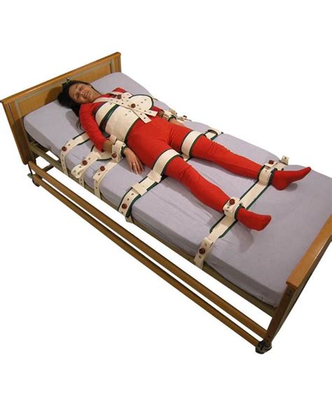 A Woman Laying On Top Of A Bed With Straps Attached To Its Sides