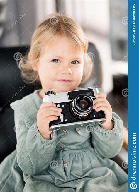 Portrait Of Adorable Cute Baby Girl Holding In Arms Little Photo Camera