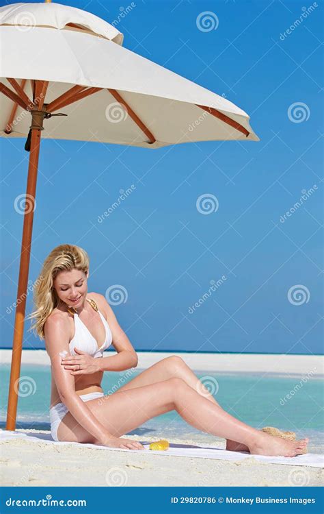 Woman Applying Sun Lotion On Beach Holiday Stock Photo Image Of Parasol Blue