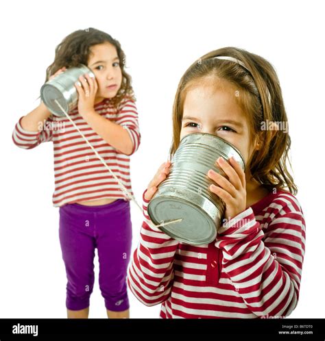Two Girls Talking On A Tin Phone Isolated On White Stock Photo Alamy