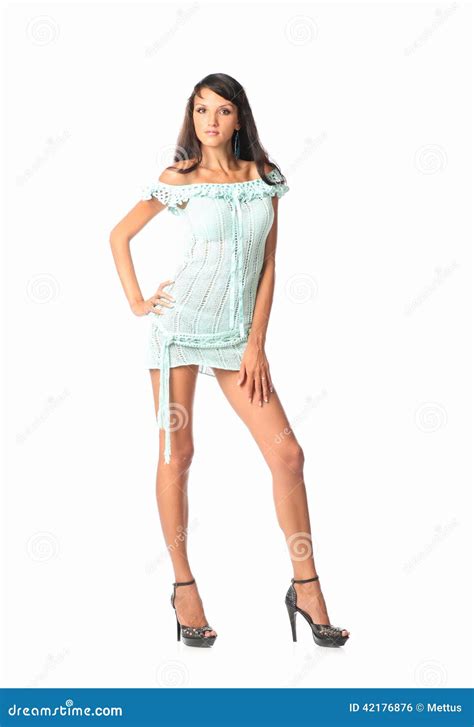 beautiful woman in full length posing in short sexual party dress over white background stock