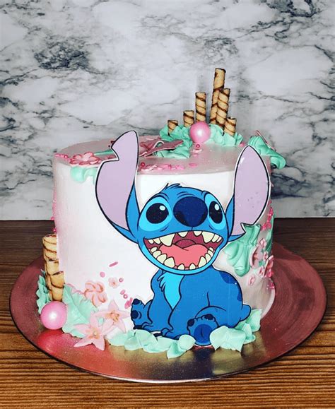 A Birthday Cake Decorated With An Image Of Stitch