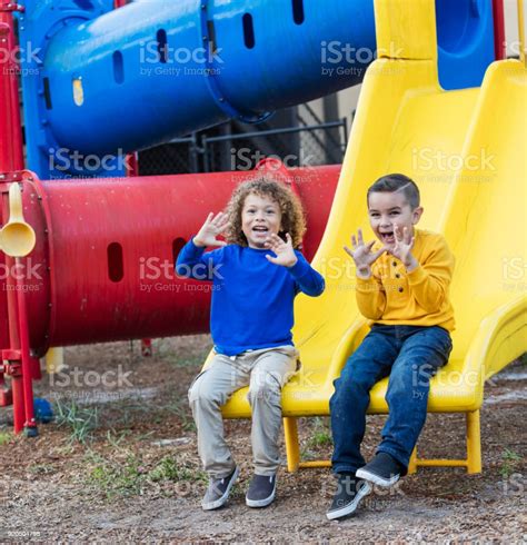 Two Multiethnic Boys Playing On Playground Stock Photo Download Image