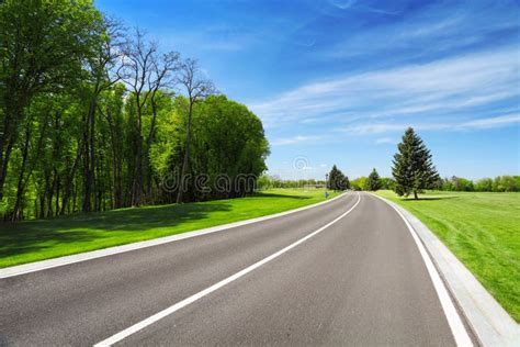 Road Between Trees And Grass On Roadside Stock Photo Image Of Rural
