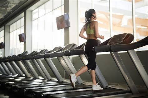 Premium Photo Young Woman Running On Treadmill