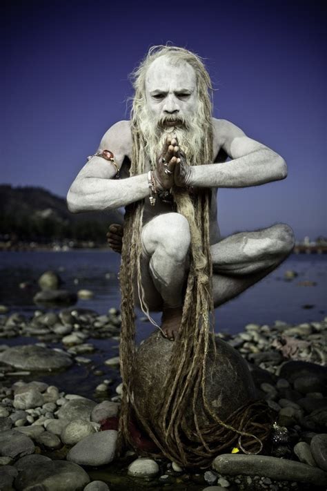 A Naked Sadhu In His Yoga Practice On The Banks Of The Ganges In