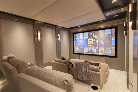 A Home Theater With Two Recliners And A Projector Screen