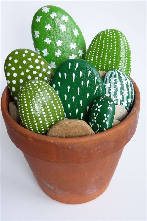 Green And White Painted Rocks In A Clay Pot