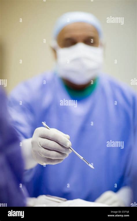 Surgeon Holding Scalpel Stock Photo Alamy