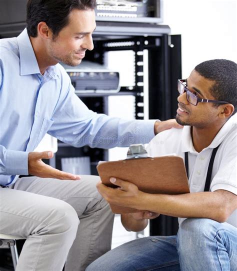 Server Room Man Or Technician With Clipboard Talking To A Client About