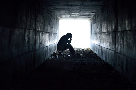 depressed man sitting in the tunnel - Hospital News