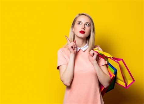 Premium Photo Blonde Girl In Pink Dress With Shopping Bags