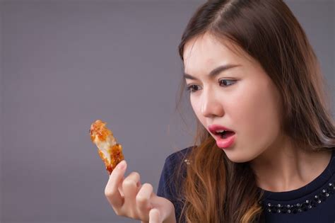 premium photo hungry asian woman eating fried chicken