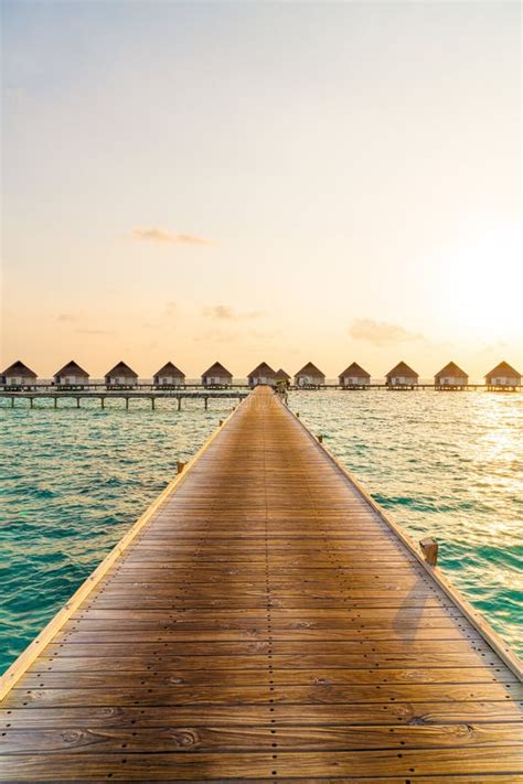 Beautiful Tropical Sunset Over Maldives Island With Water Bungalow In